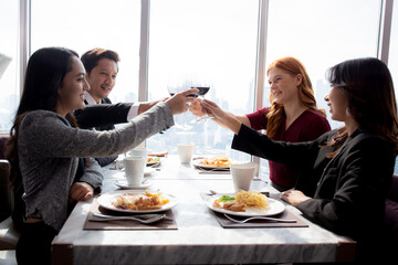 Happiness team young business people in party celebrate success holding glass of wine cheer together at restaurant luxury, friendly and social colleague, meet friend and community concept.