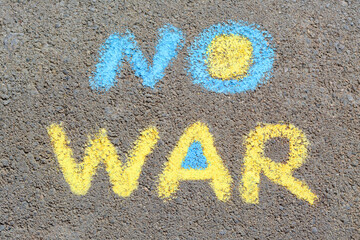 Words No War written with blue and yellow chalks on asphalt outdoors, top view