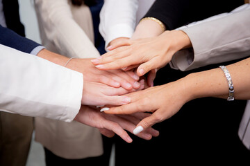 Group of business team harmonious with man and woman joining hands stack together in enterprise for...