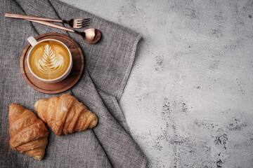 Morning aromatic coffee served with sweet croissants on top view white background, coppy space.