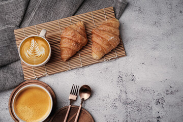 Morning aromatic coffee served with sweet croissants on top view white background, coppy space.