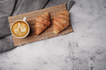 Morning aromatic coffee served with sweet croissants on top view white background, coppy space.