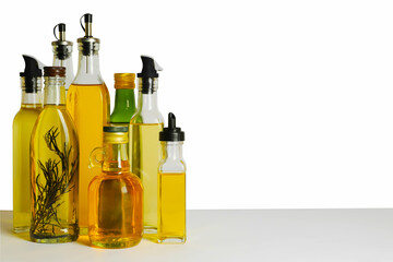 Bottles of different cooking oils on white background, space for text