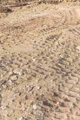 Fototapeta na wymiar Wheel tracks on sand dirt