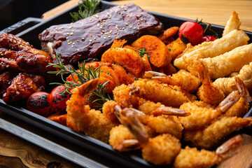 Shrimp platter in batter, fish and chips, rustic potatoes, ribs and wings in BBQ sauce