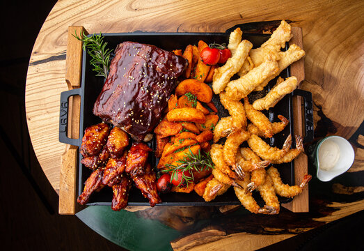 Shrimp platter in batter, fish and chips, rustic potatoes, ribs and wings in BBQ sauce