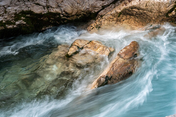 The Soca river flowing through a wild mountain landscape of the Julian Alps in Slovenia