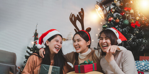 Group of young adult millennial Asian people singing playing guitar ukulele and having fun in living room celebrating Christmas eve together. Young people celebrating New Year at home party.