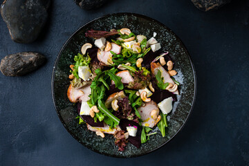 Salad of chicken breast, feta cheese, arugula, lettuce, cashew nuts with olive oil.