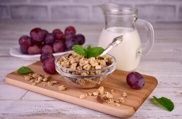 Granola with raisins and milk on a white background.Healthy breakfast.	