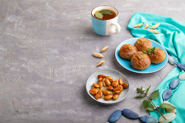 Traditional turkish dessert sekerpare with almonds and honey on gray concrete, side view, copy space.