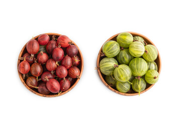 Fresh red and green gooseberry in clay bowl isolated on white, top view.