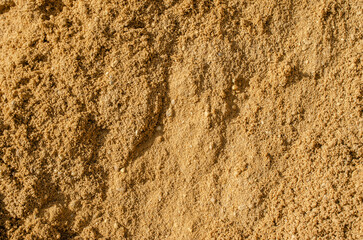Background of yellow-brown building sand.