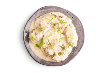 Stewed chicken fillets with coconut milk sauce isolated on white  top view, close up.