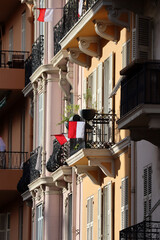 Monaco, Monaco - 11.19.2022 : Flags of Monaco on the windows of the Principality in honor of the...