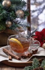 Steaming hot tea with lemmon slice with holiday decorations