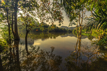 Blurred panoramic nature background on the large lake, reflected by the water of trees, the atmosphere is surrounded by big mountains