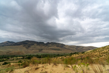 Sand dunes Sarykum in Dagestan with gray clouds