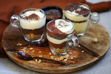 Healthy desserts in mugs. Vanilla and chocolate puddings with chia seeds and linseeds.