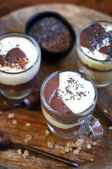 Healthy desserts in mugs. Vanilla and chocolate puddings with chia seeds and linseeds.