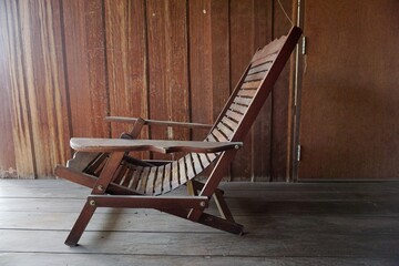 Adjustable chair for sitting or lying down made of solid wood.