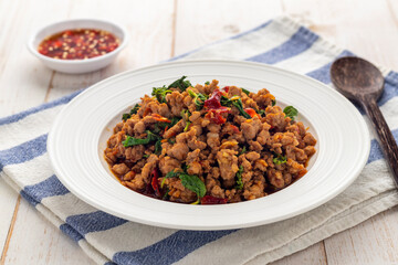 Stir-fried minced pork with holy basil leaves or pad kra pao moo, a simple-easy-delicious Thai hot dish served diners from street food carts to restaurants in Thailand.