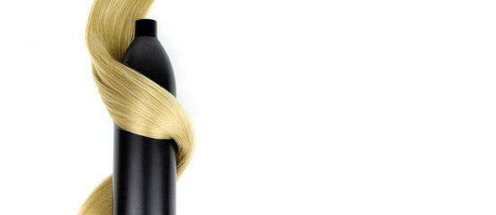 Different professional hairdresser tools shampoo bottle and strand of blonde hair on white background, flat lay. Background for a beauty salon.