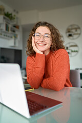 Young happy pretty business woman student sitting at desk at home office with laptop computer...