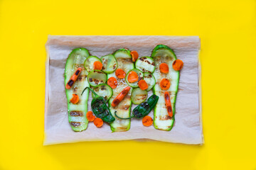 Baked or grilled vegetables on yellow background. Cooking delicious food at home. Close-up