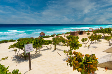 CANCUN, MEXICO - APR 2022: Sandy beach with azure water on a sunny day near Cancun, Mexico