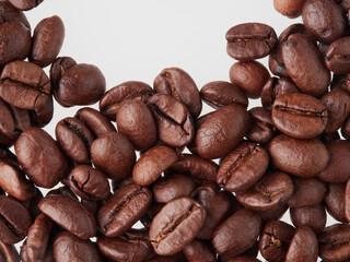 roasted coffee beans macro on a white background with free space