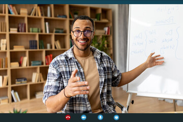 Distance education and technology. Young arab male teacher having video conference, having foreign...