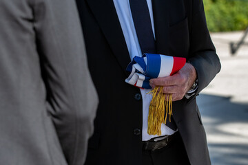An official people hold the tricolor scarf of french deputy or mayor 