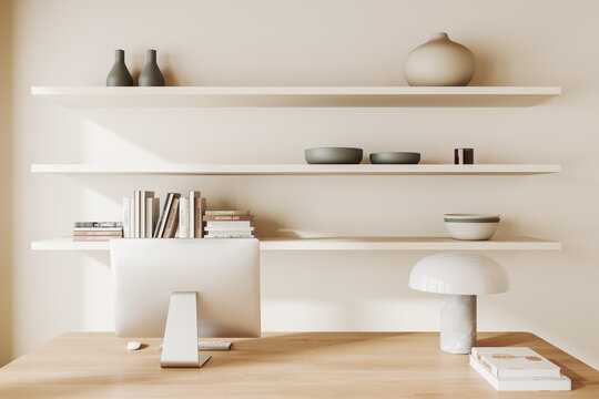 Beige office interior with table and pc computer, shelf with decoration