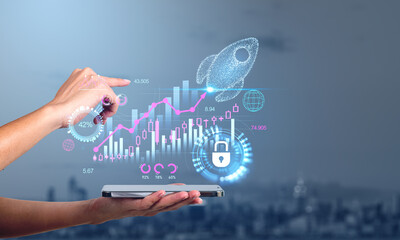 Businesswoman holding smartphone touching digital interface with rocket startup