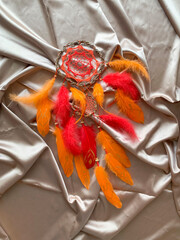 Close-up red dream catcher bohemian wall hanging craft indoors