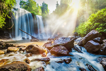 Obraz premium Tropical waterfall in morning with sun rays. Phnom Kulen, Cambodia