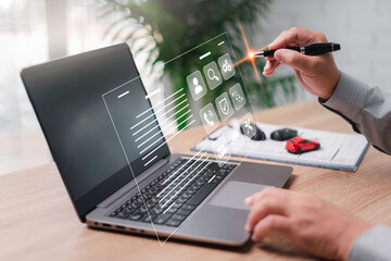Car service staff and Insurance check the documents and conditions of insurance on a virtual screen and use laptop and a pen point on smart document