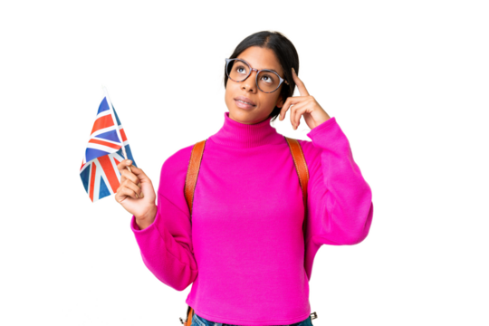 Young African American woman holding an United Kingdom flag over isolated chroma key background having doubts and thinking