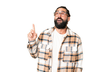 Young man with beard over isolated chroma key background thinking an idea pointing the finger up
