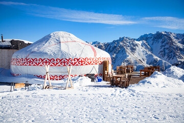 Small restoran from yurt house in the mountains against the backdrop of snow mountains
