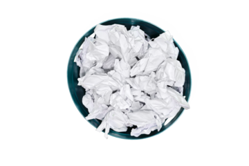 Plastic trash can being filled with crumpled sheets of white paper, isolated 