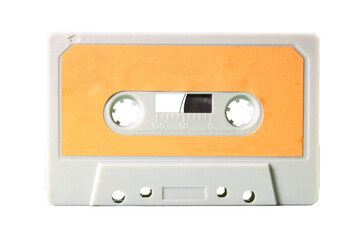 An old vintage cassette tape from the 1980s (obsolete music technology). White-grey plastic body and warm yellow label, isolated on white.	cassette,tape,white,grey,yellow,warm,used,vintage,music,1980s