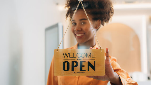 Woman Setting Open Sign Board Through The Door Glass., Owner Of A Small Business Changing The Sign For The Reopening.