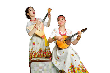 Women musicians in Russian folk dresses with musical instruments on a isolated white background. Happy artists from Russia in white national clothes with stringed musical instruments