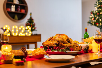 Family have a celebration dinner in party with wine, champagne on Merry Christmas Eve Xmas on holiday at home. Roasted Thanksgiving Turkey with Side Dishes.Thanksgiving Celebration .
