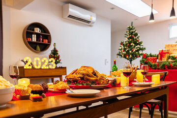 Family have a celebration dinner in party with wine, champagne on Merry Christmas Eve Xmas on holiday at home. Roasted Thanksgiving Turkey with Side Dishes.Thanksgiving Celebration .
