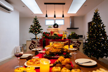 Family have a celebration dinner in party with wine, champagne on Merry Christmas Eve Xmas on holiday at home. Roasted Thanksgiving Turkey with Side Dishes.Thanksgiving Celebration .
