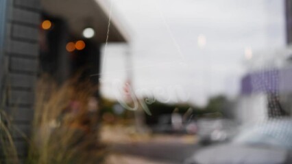 Employee opening coffee shop, turning sign board on door, small urban business