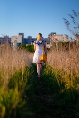 Woman lonely walking along grassy path